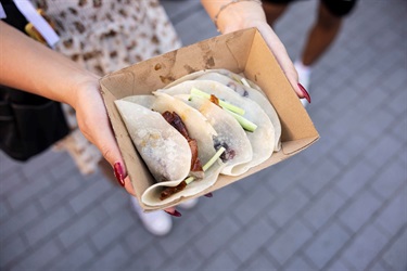 2023 Cabramatta Moon Festival hands holding-pecking duck pancake.