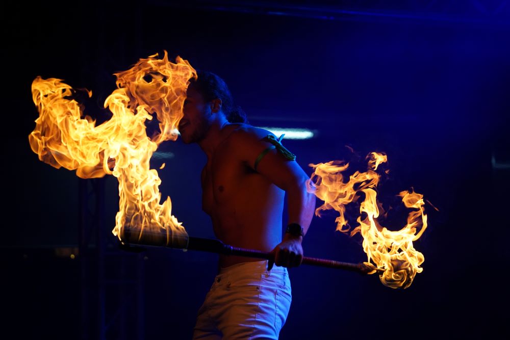 Fire dancing man performing on stage