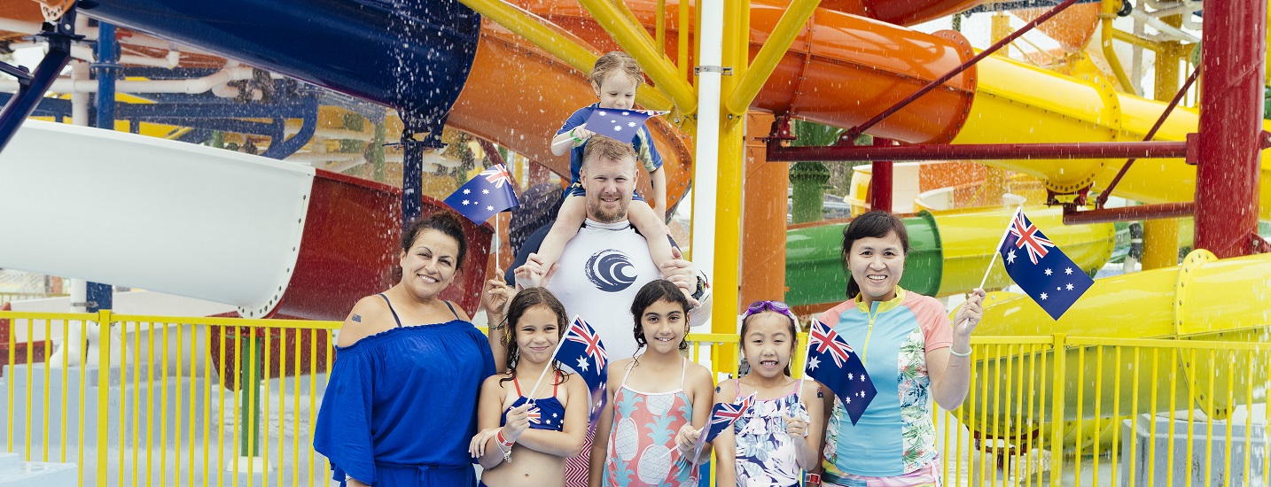 Families smiling and posing with Australian flags at Aquatopia