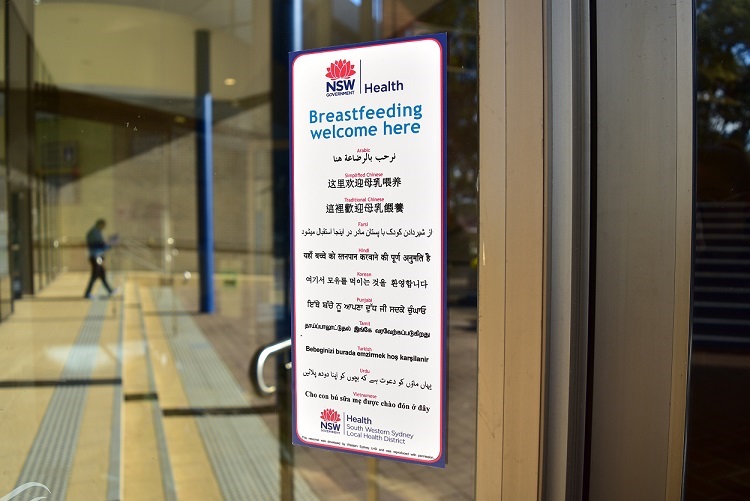 Glass door of a public building with a sign saying breastfeeding welcome here