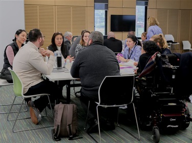 Table of people conversing during a group activity at the Fairfield Conversations summit