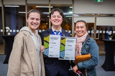 JJ Crosbie posing with companions and showing Certificate of achievement for Community Spirit