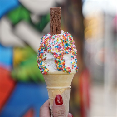 Ice cream cone with rainbow sprinkles and chocolate flake
