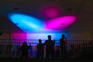 Local band, DM SZN, performing under blue and pink lights at Fairfield Youth Centre. Photographed by Jennifer, Tyna & Jacintha