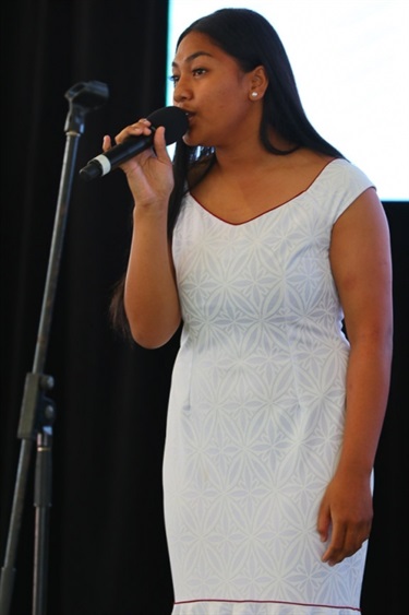 Young woman singing into a microphone