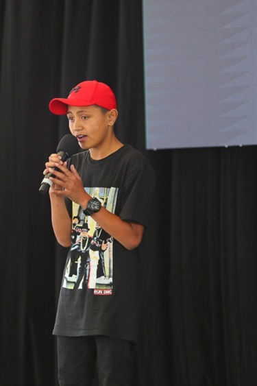 Young man singing into a microphone