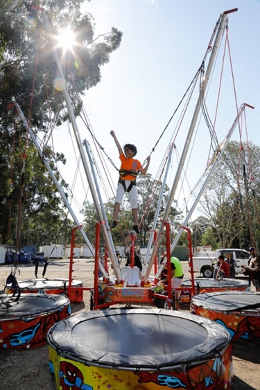 Young child playing on bungee trampoline