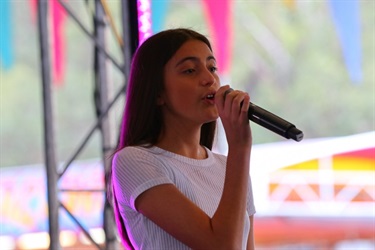Young girl singing into microphone