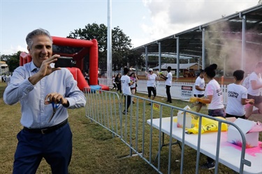 Mayor filming festival go-ers running the Rainbow Run