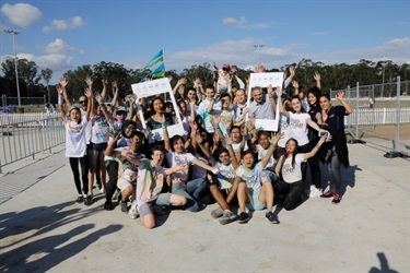 Young people posing with Council members holding Instagram frame props