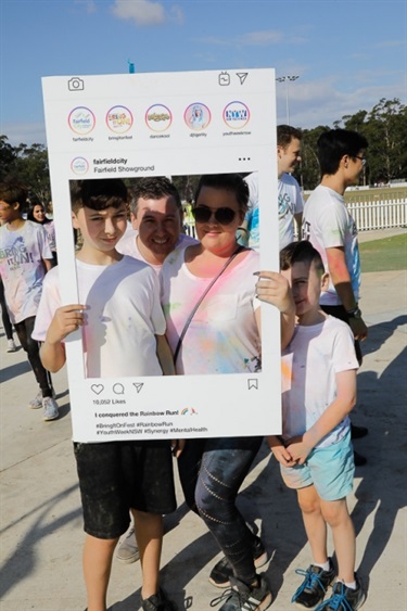 Family posing with Instagram frame prop