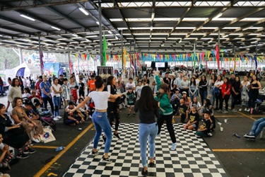 Festival go-ers watching young people jumping on dance floor