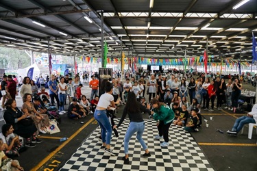 Festival go-ers watching young people jumping on dance floor