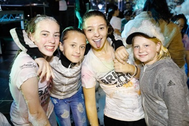 Young girls covered in foam smiling and posing