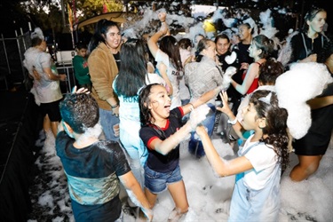Young children covered in foam on the dance floor