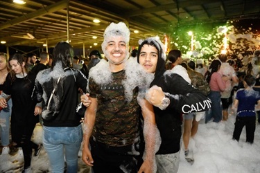 Two boys covered in foam smiling and posing