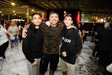 Three boys posing while covered in foam