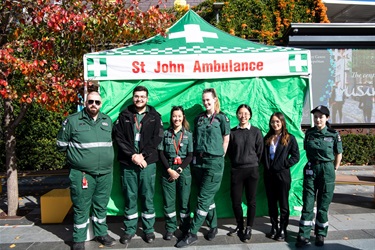 St John Ambulance staff members smiling and posing in front of their tent