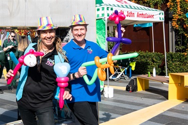 Kozi and Pinky entertainers smiling and posing while holding a variety of different colourful balloon creations