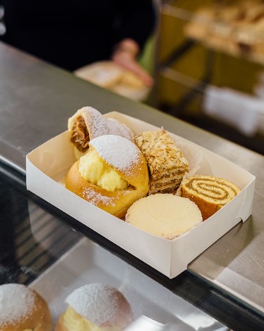 Assorted sweet pastries and dessert in a white box