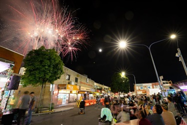 Crowd watching fireworks at night in Arthur Street