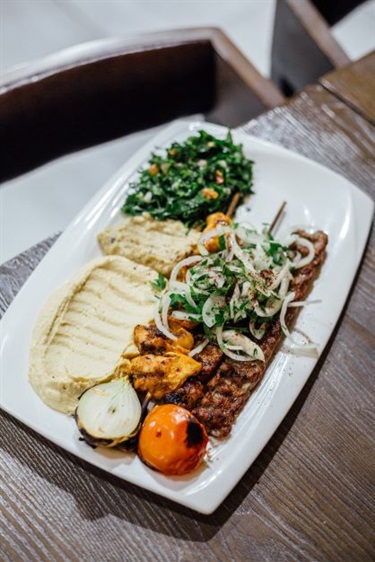 A plate of Lebanese skewers with sauces and salads