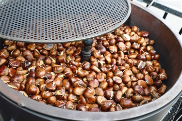A large pot filled with brown chest nuts