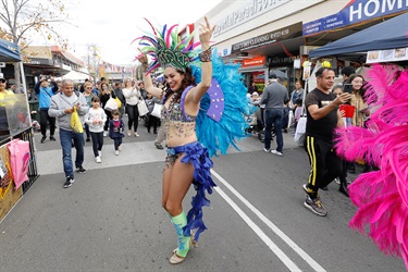 Brazilian dancer wearing blue costume dancing for onlookers