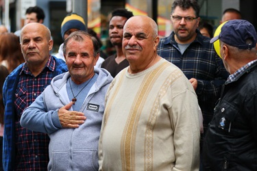 Men smiling and standing together