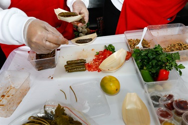 Women preparing food with ingredients on the table