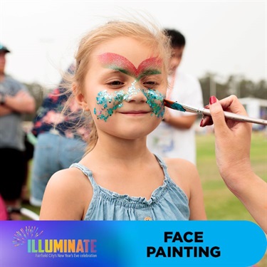 Young girl having her face painted