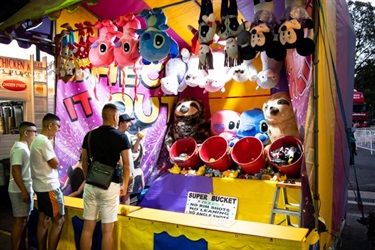 A group of people playing a carnival game
