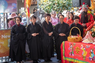 Group of women wearing traditional black Chinese robes