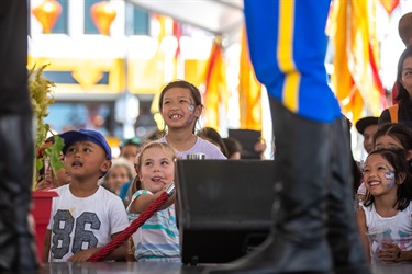 Young children watching the performers on the stage