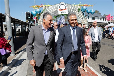 Mayor Frank Carbone smiling while walking past the District 9 archway