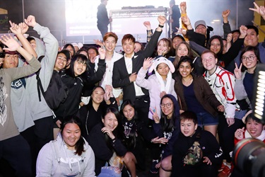 SBS Pop Asia Host Andy Trieu and Korean idol Kevin Kim smiling and posing with fans