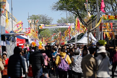 Crowd of guests walking through John Street, under Moon Festival banner