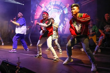 Kookies N Kream dance team performing hip hop routine on the stage