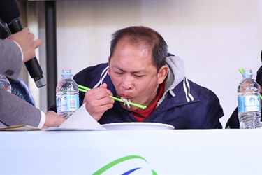 Man eating Vietnamese noodle dish with chopsticks