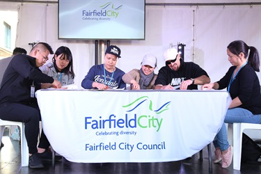 Group of people sitting at a table and eating prawns