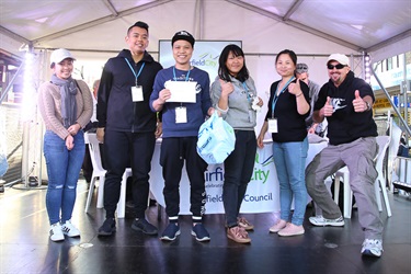 Group of people smiling and posing on the stage