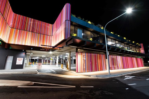 Street level view of the outside of Dutton Plaza carpark at night