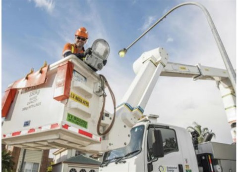 Man inside crane getting ready to install new LED lights