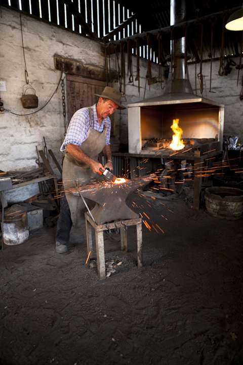 Demonstration by volunteer Grigory Rogojkin in Robson Bros. Blacksmith’s at Fairfield City Museum and Gallery. Image courtesy of Fairfield City Museum and Gallery.