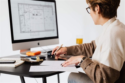 Woman doing her house construction planning on her computer