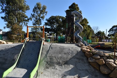 small slide in foreground and large spiral tube slide in background