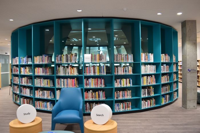 Fairfield library blue bookshelf, with a blue reading chair