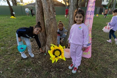 2025 Easter kids searching for chocolate eggs.