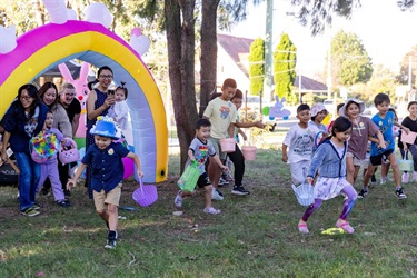 Kids playing Easter Egg Hunt at Bareena Park in Canley Vale.