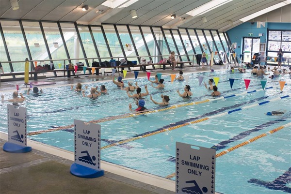 Group of people doing exercise in swimming pool